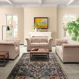 Classic Alvis Flared Arm Sofa and armchairs with a dark wood coffee table and patterned rug.