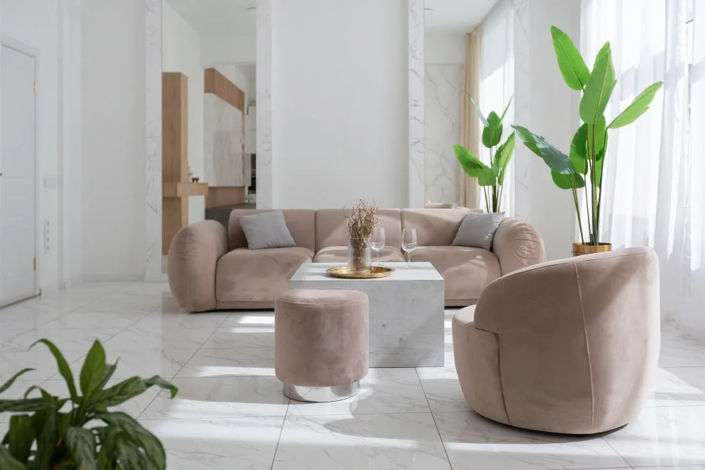 A cozy living room featuring a beige couch and a stylish coffee table, creating a warm and inviting atmosphere. 