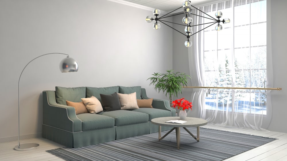 A cozy living room featuring a comfortable couch, a stylish lamp, and a modern table, creating a welcoming atmosphere.