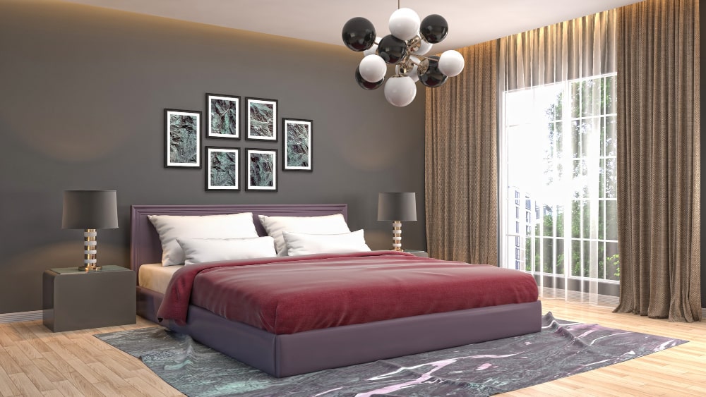 A contemporary bedroom featuring a spacious bed and a large window allowing natural light to fill the room.